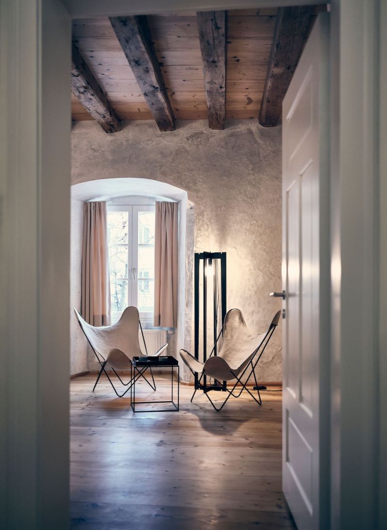 Hotel Kontor: Contemporary interiors within an historic building showing wooden timber rafters and Italian seating | Kontor Boutique Hotel Hall in Tirol Austria