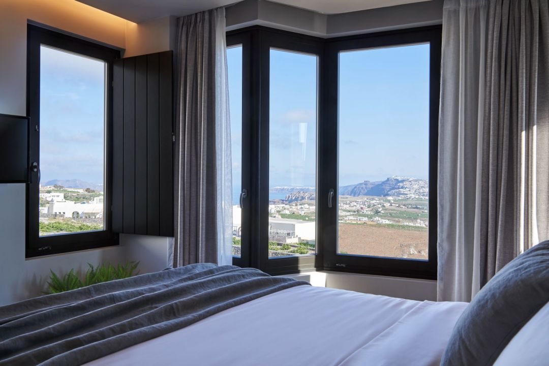 Bedroom with panoramic views | Apikia Suites Pyrgos Santorini | Design Hotel Greece | The Aficionados 