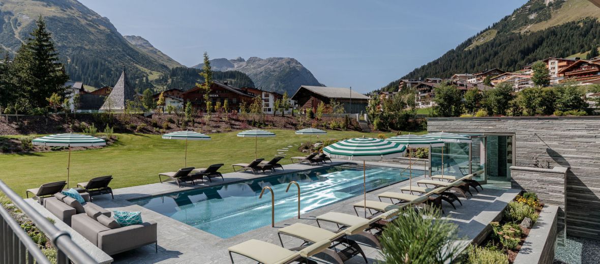 Outdoor Pool with the mountains of Arlberg | Snowy alps at the Hotel Arlberg Lech, Austria 