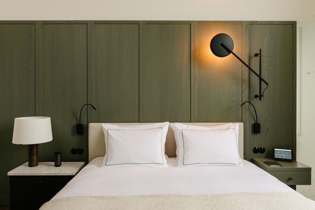 Green Panelled walling in luxury hotel bedroom | lHotel August Antwerp designed by architect: Vincent Van Duysen | The Aficionados