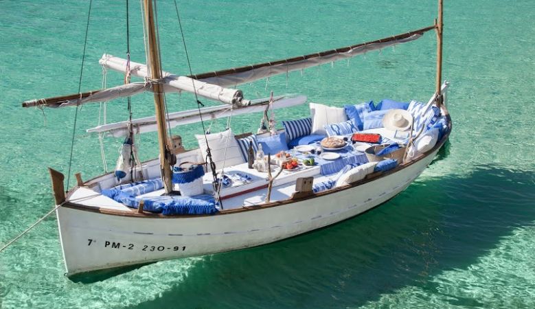Fishing boat with cushions made from traidtional IKAT  - IKAT Blue & white textile from Mallorca, that bears a characteristic pattern obtained by the process of resist dying, and the island of Mallorca is the only place where you can still visit family-ru