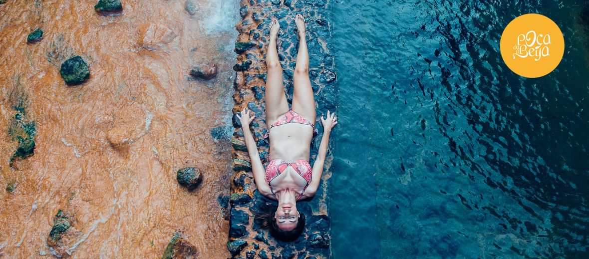 Photograph of a woman enjoying the architectural masterpiece that is São Miguel’s Poça da Dona Beija thermal spring in the Azores